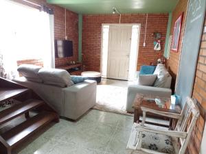 a living room with a couch and a table at Casa aconchegante em Canela in Canela