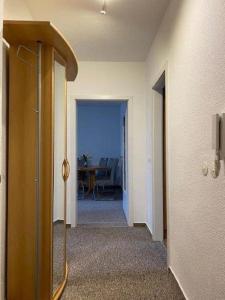 a hallway of a room with a door and a table at Gästewohnung KL. WZL 40_4 