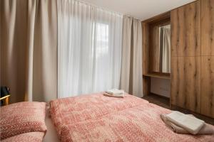 a bedroom with a bed with two towels on it at Apartmán Na vŕšku in Dolný Kubín