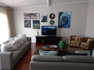 a living room with a couch and a tv at 20 on Beach Road in Swakopmund