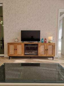 a wooden entertainment center with a flat screen tv in a living room at Morkinali Apartment in Tbilisi City