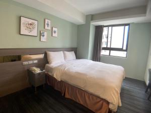 Postel nebo postele na pokoji v ubytování Bonjour Hotel
