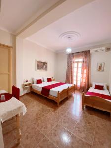 een slaapkamer met 2 bedden en een raam bij Hotel plage d'or in Jijel