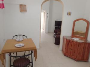 a kitchen with a table and chairs and a mirror at Djerba house in Houmt Souk