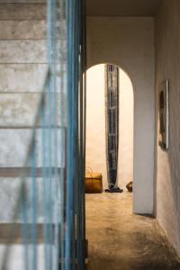 a hallway with a window and a mirror in a room at Dechiu in Hoi An
