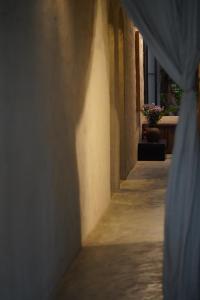 an alley with a blue curtain in a building at Dechiu in Hoi An
