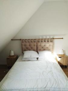 1 dormitorio con 1 cama blanca grande y 2 mesitas de noche en APPT 4P - Manoirs 1 à la Mer Chez Claudette & Marc, en Courseulles-sur-Mer