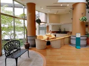 a lobby with a chair and a table in a building at Wellness Forest Ito - Kyoritsu Resort in Ito