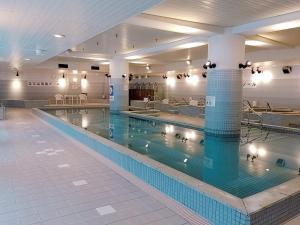 a large swimming pool in a large building at Wellness Forest Ito - Kyoritsu Resort in Ito