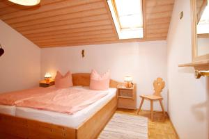 a bedroom with a bed and a skylight at Braunhof in Bad Feilnbach