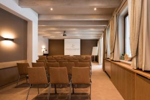 a conference room with chairs and a podium at Hotel Medrazerhof in Fulpmes