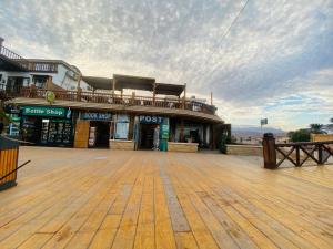 a building with a wooden floor and a wooden deck at Neptune Hotel in Dahab