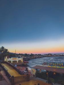 a view of a river at sunset with a pier at Neptune Hotel in Dahab
