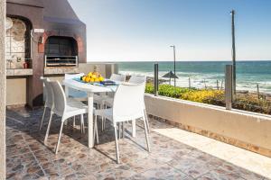 a table and chairs with a view of the ocean at LA CRETE SANDS NO 7 in Uvongo Beach