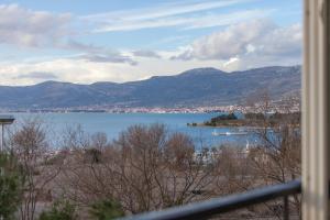 a view of a large body of water with mountains at Apartment Fabris in Split