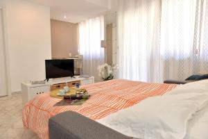 a hotel room with a bed and a television at Tizi Apartments Corso Reginna in Maiori +33 photos