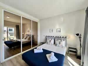 a bedroom with two beds and a large mirror at Albufeira Delight with Pool by Homing in Guia