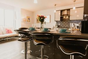 a kitchen with a table with chairs and a counter top at The Sun Deck Apartment - Westbrook Bay Beach - By Goldex Coastal Breaks in Kent