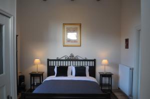 a bedroom with a large bed with two night stands at De Parel van Pekel in Nieuwe Pekela