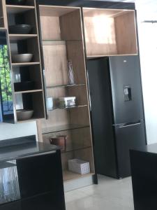 cocina con nevera y algunos estantes en Sibani@ Dolphin coast, en Ballito