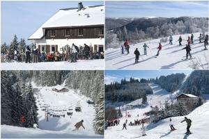a group of people skiing down a snow covered slope at Les Gites de l étang :Studio à 20 mn de Gerardmer in La Chapelle