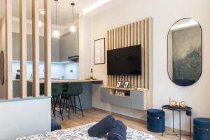 Televízia a/alebo spoločenská miestnosť v ubytovaní Basilica Dream Apartment
