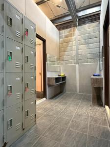 a bathroom with metal lockers and a tile floor at YCC Forest Campsite in Puli