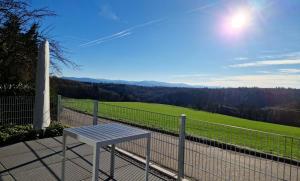 - une table sur un balcon avec vue sur un champ dans l'établissement Tinyhaus Adam, à Freiamt