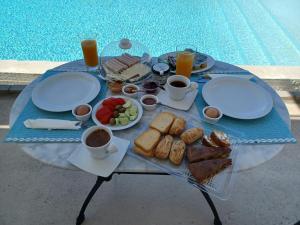 a table with a tray of breakfast food on it at Karinta Bay Apartments in Chios