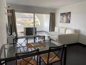 a living room with a couch and a table at Carpe Diem Cadaqués in Cadaqués
