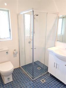 a bathroom with a shower and a toilet and a sink at Maria Motel in Moree