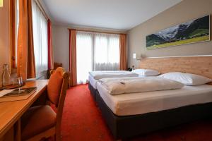 Postel nebo postele na pokoji v ubytování Hotel Sonnwendhof Engelberg
