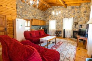 a living room with a red couch and a refrigerator at Sakin Vadi Villas in Marmaris