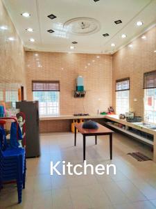 a kitchen with a table in the middle of a room at Dorry Villa 2226 in Port Dickson