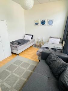 a living room with two beds and a couch at City Apartments Erfurt in Erfurt