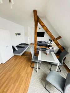 a living room with a table and chairs at City Apartments Erfurt in Erfurt