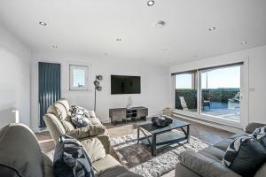 a living room with two couches and a tv at Luxury Apartment with Sea Views in Arbroath