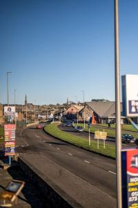 a street with cars parked on the side of the road at Sea View Luxury Apartment 3 bedrooms Free Parking - By Coast Apartments in Arbroath