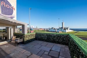 a building with a retaining wall and a patio at Luxury Apartment with Sea Views in Arbroath