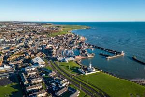 an aerial view of a harbor next to the ocean at Sea View Luxury Apartment 3 bedrooms Free Parking - By Coast Apartments in Arbroath