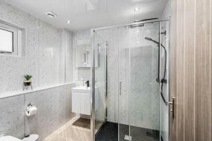 a bathroom with a glass shower and a sink at Sea View Luxury Apartment 3 bedrooms Free Parking - By Coast Apartments in Arbroath +37 photos
