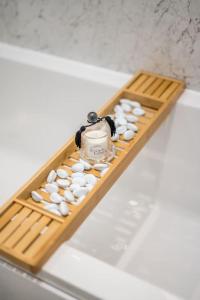 a wooden tray with pills on top of a bath tub at Sea View Luxury Apartment 3 bedrooms Free Parking - By Coast Apartments in Arbroath
