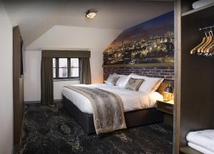 a hotel room with a bed and a painting on the wall at Abel Heywood Boutique Hotel in Manchester