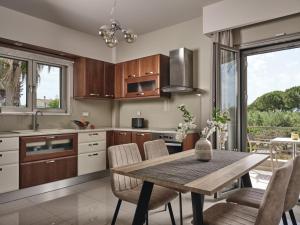 a kitchen with a wooden table and chairs and a dining room at La Palma Apartment in Zakynthos Town