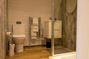 a bathroom with a toilet and a glass shower at Hollins Farm - Dog Friendly, Self Catering Holiday Lodges in Knaresborough