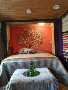 a bedroom with a tree mural on the wall at Loma-Paksu in Köngäs