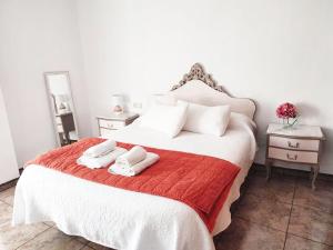 a bedroom with a bed with two towels on it at La Encina in Alhama de Granada