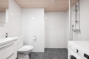 a white bathroom with a toilet and a shower at Forenom Serviced Apartments Jyväskylä Vaasankatu in Jyväskylä +23 photos