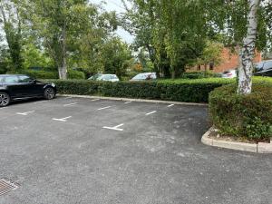 a parking lot with a car parked in it at Newly Refurbished Luxury Hotel Style Accommodation in Milton Keynes