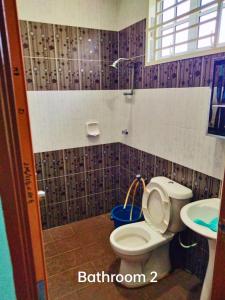 a bathroom with a toilet and a sink at Dorry Villa 2226 in Port Dickson